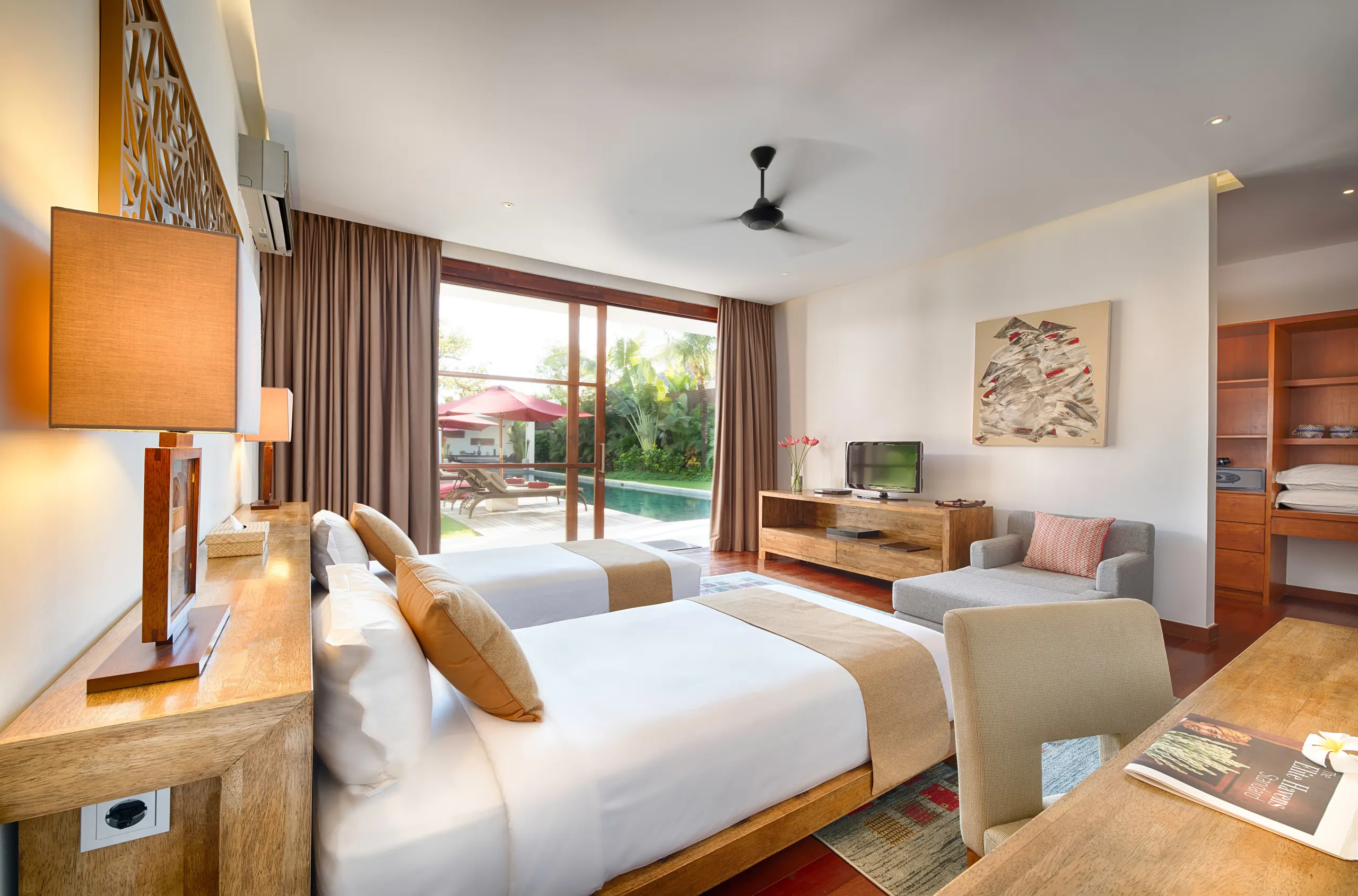 A garden-level king-or-twin suite at Casa Brio, made up as twins, opening onto the pool deck