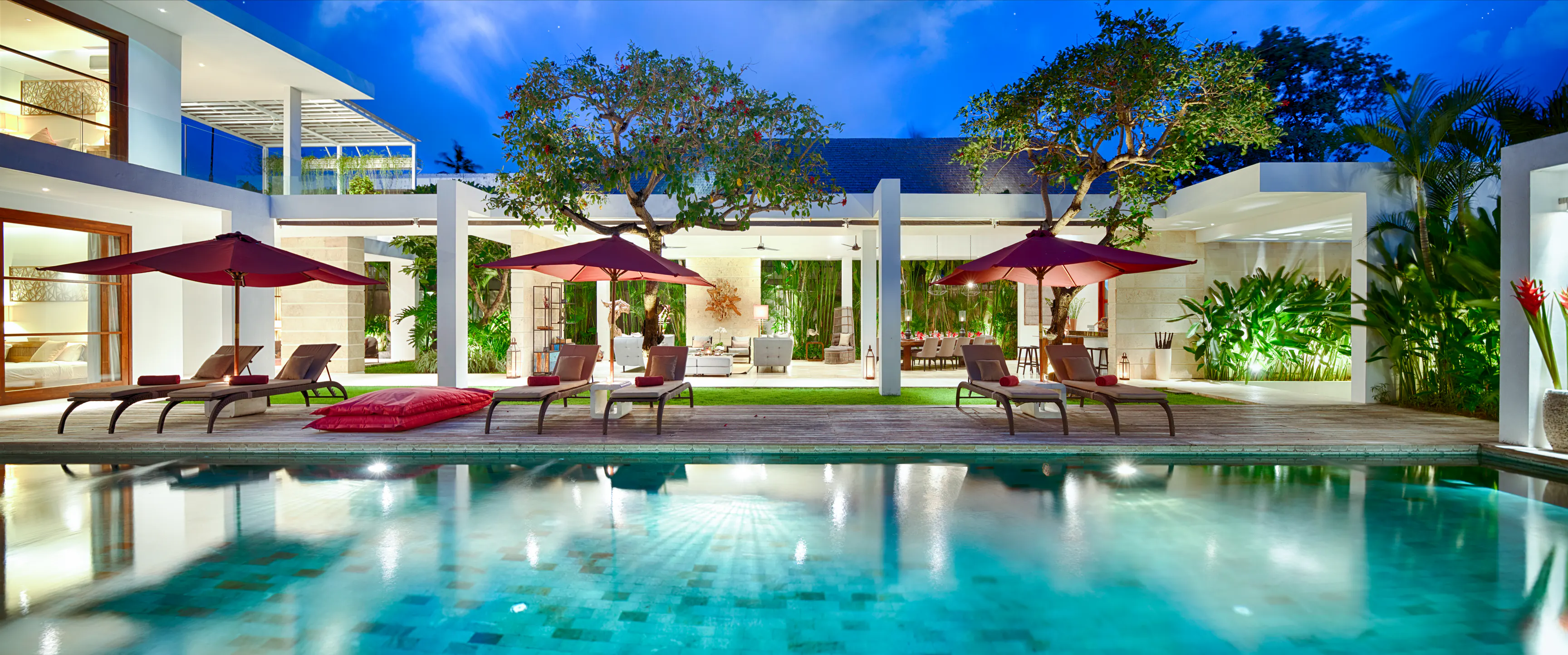 Casa Brio at night, the pool and pavilion lit from within