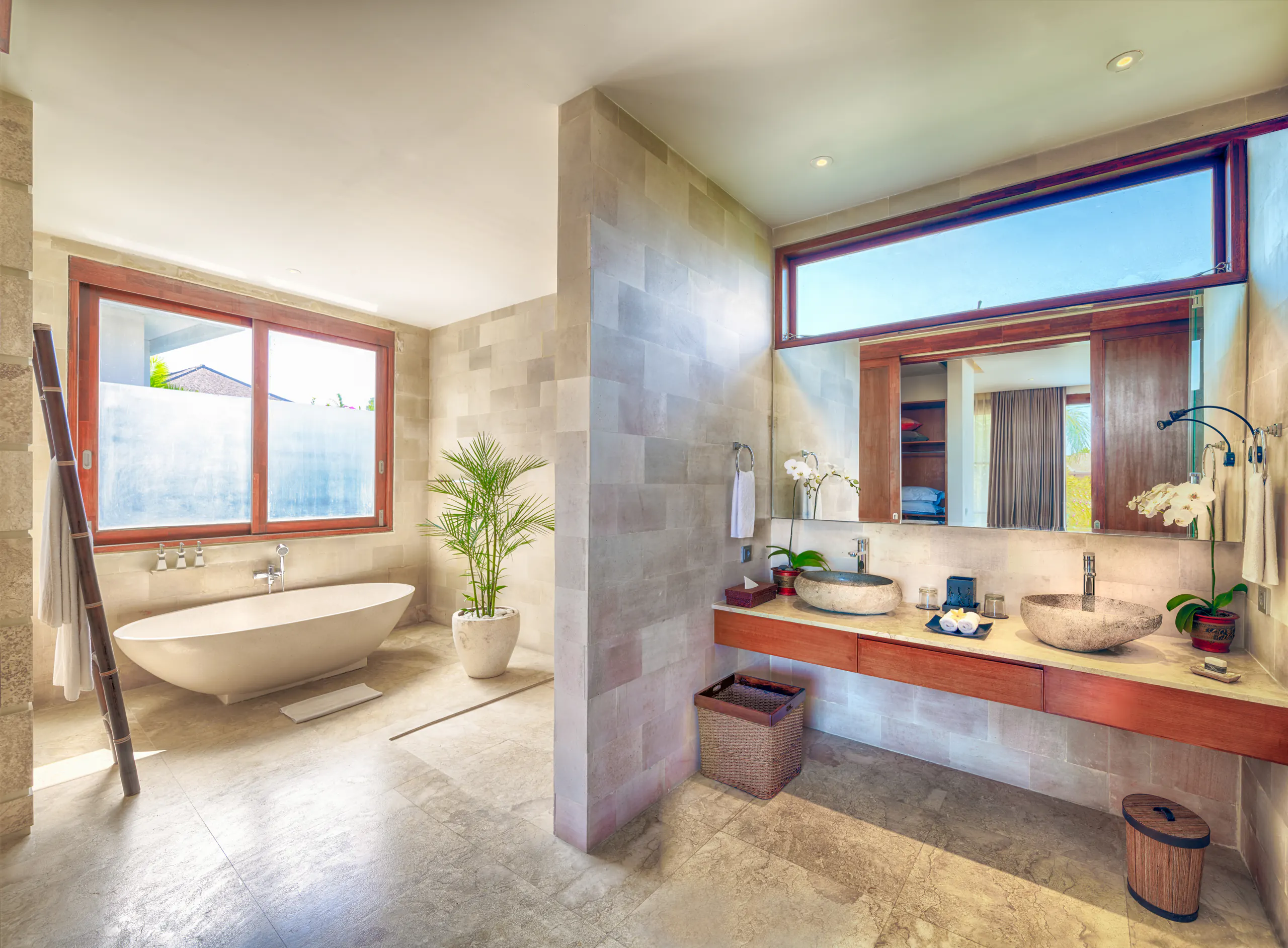 A master bathroom at Casa Brio, freestanding tub and twin carved stone basins on a timber vanity