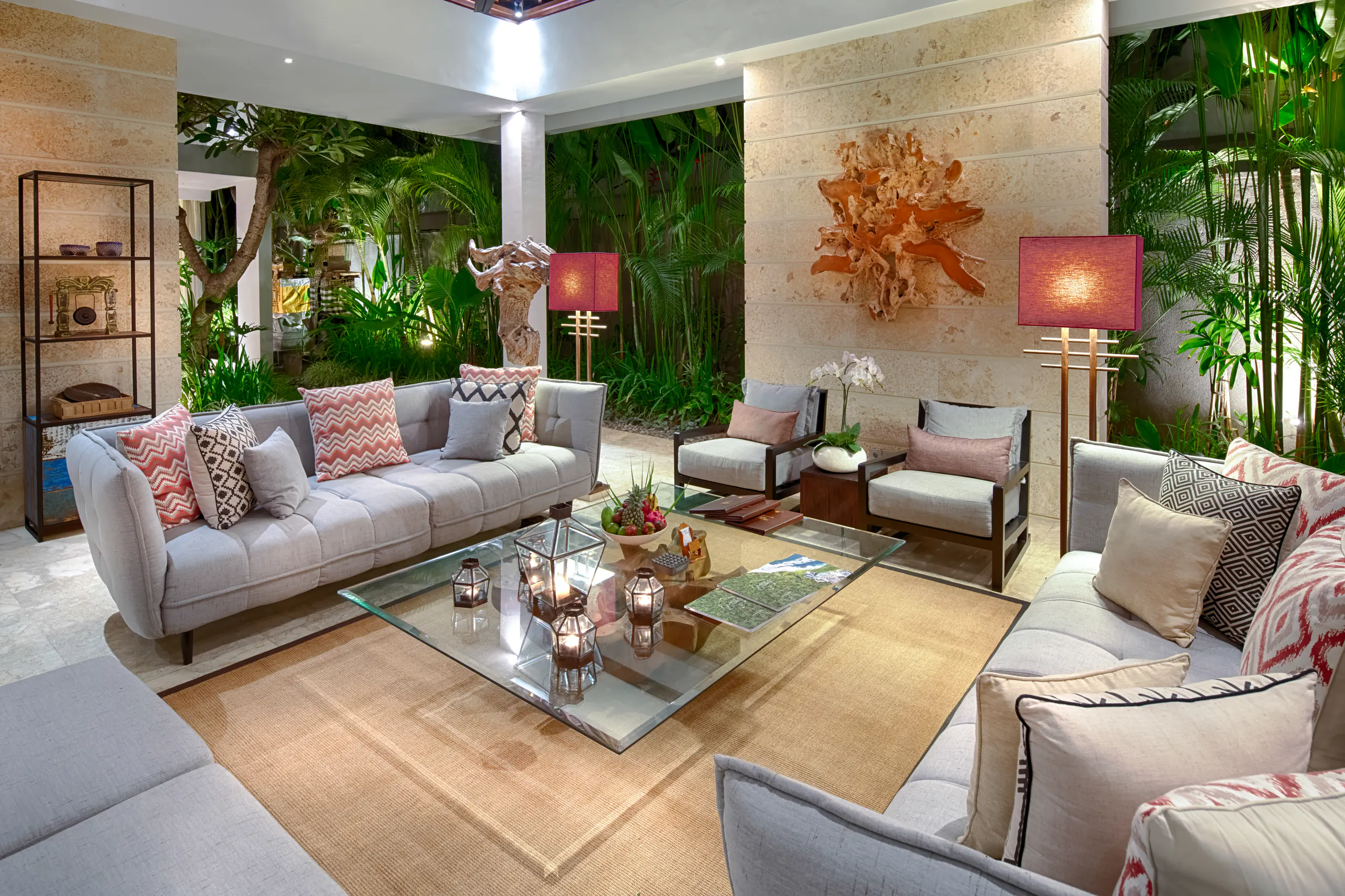 Super-sized grey sofas and armchairs in the pavilion at Casa Brio, facing a coral-form wall sculpture